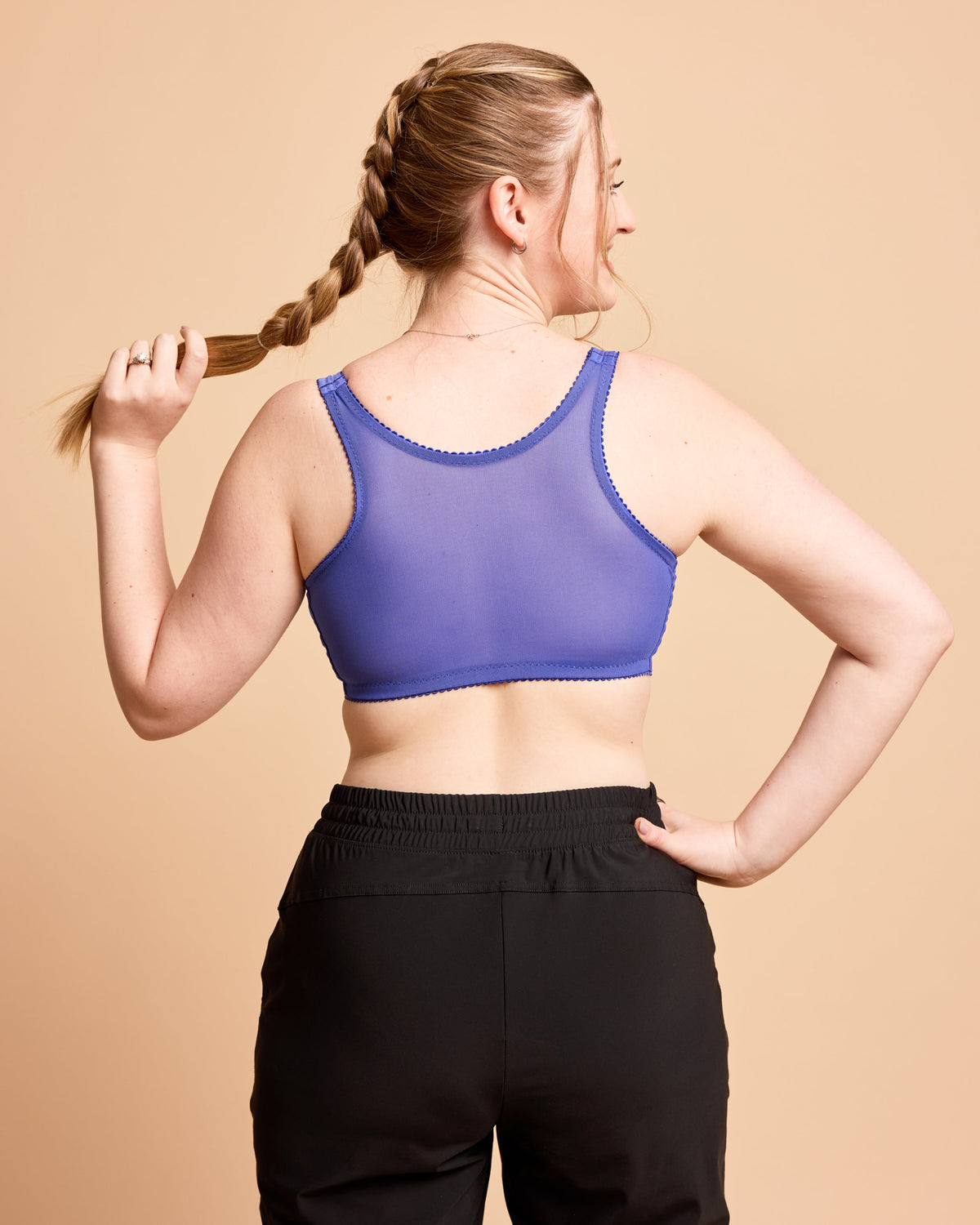 Cashmerette Somerville Sports Bra PDF sewing pattern, woman wearing a purple sports bra and black leggings
