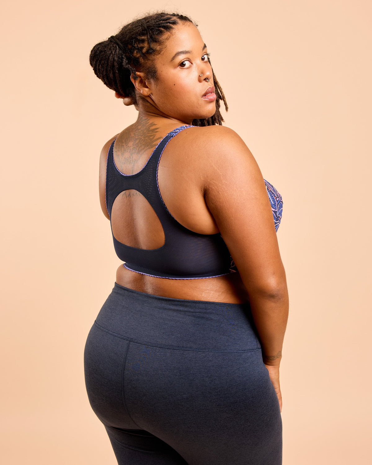 Cashmerette Somerville Sports Bra PDF sewing pattern, woman wearing a black sports bra and leggings