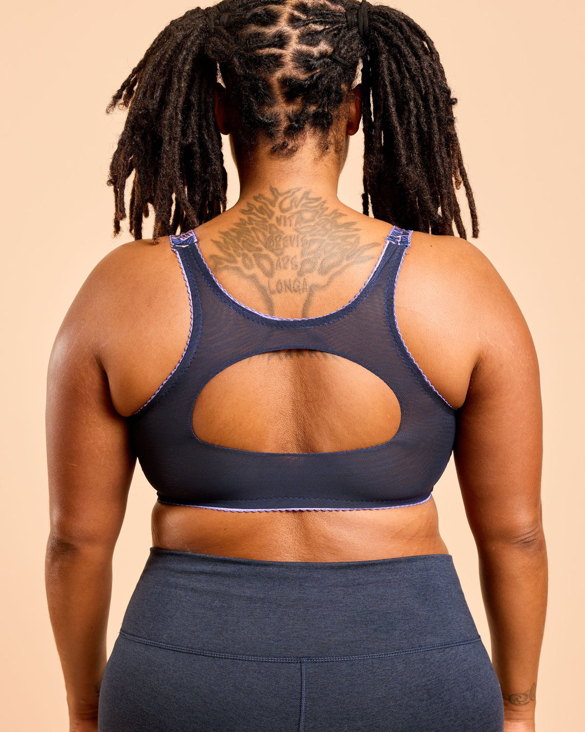 Cashmerette Somerville Sports Bra PDF sewing pattern, person wearing a navy blue sports bra and leggings