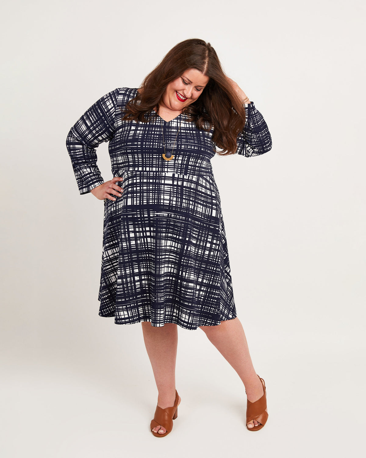 Cashmerette Turner Dress PDF sewing pattern, woman wearing a blue plaid dress, navy print side view