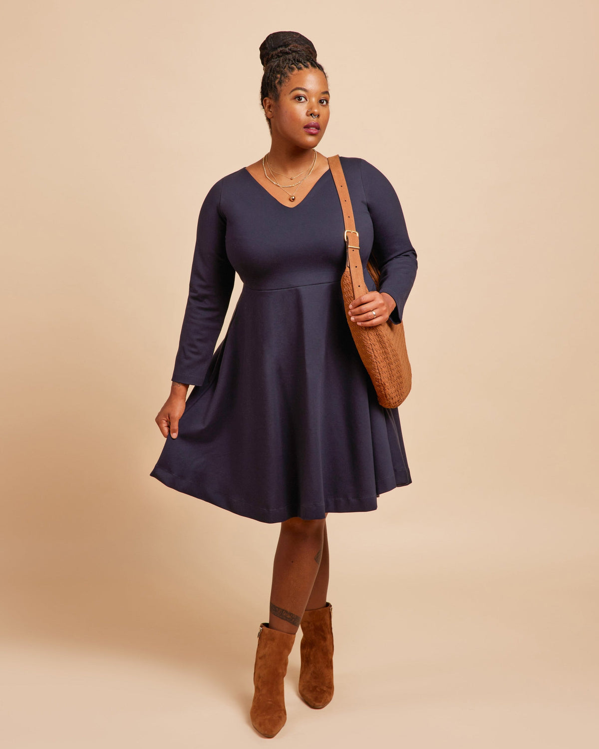 Cashmerette Turner Dress PDF sewing pattern, woman wearing a navy blue dress with brown boots and bag