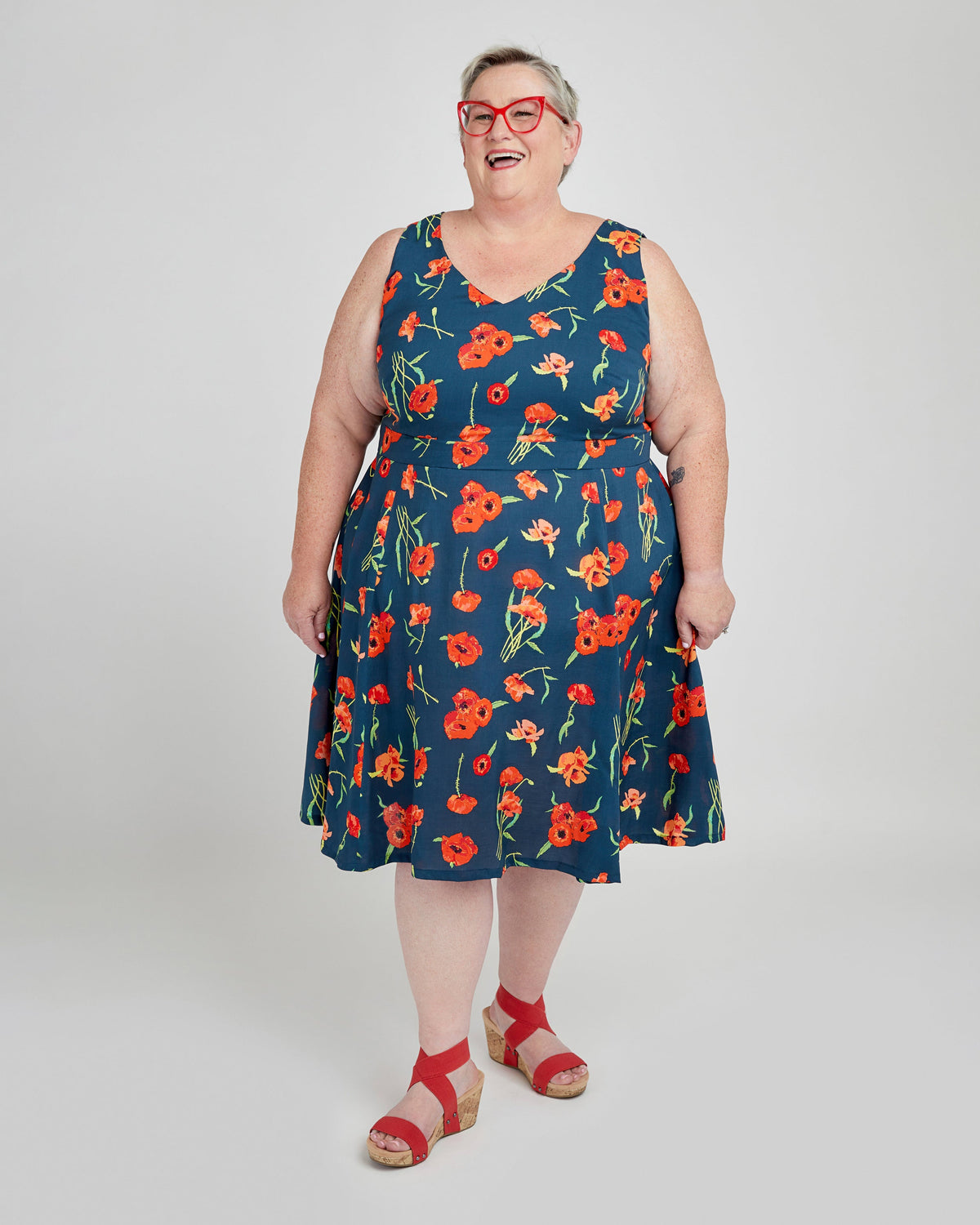 Cashmerette Upton Dress and Skirt Plus expansion pack PDF sewing pattern, woman wearing a blue dress with red floral pattern