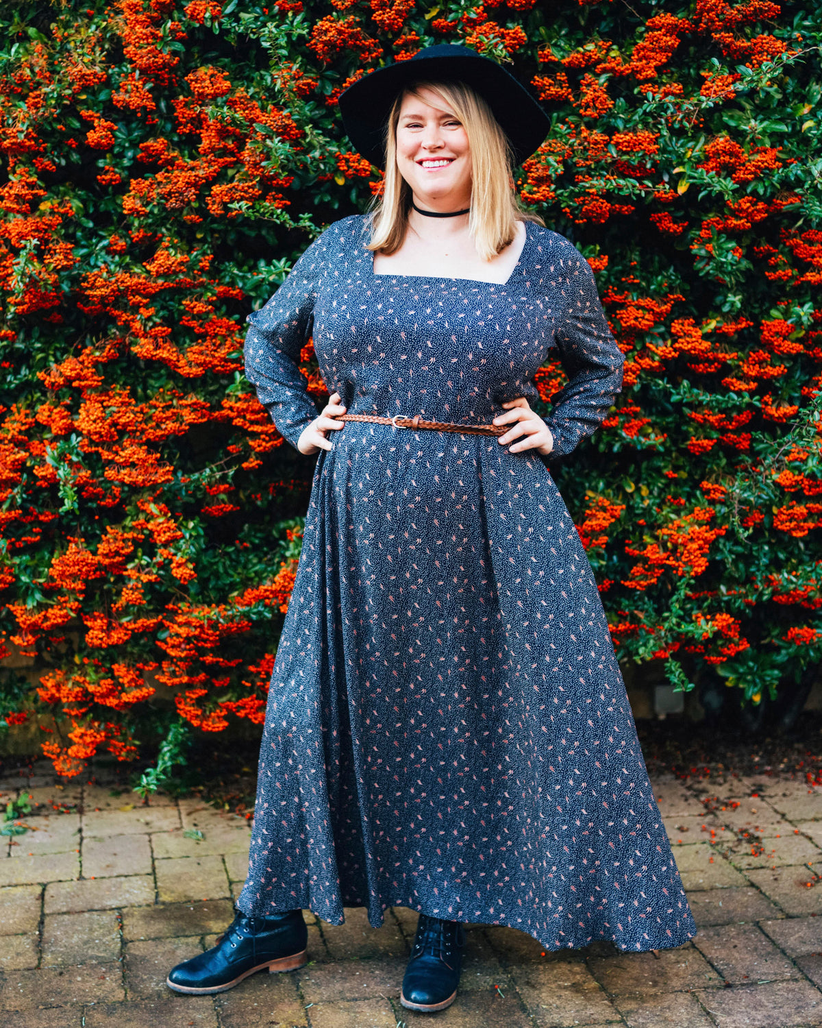 Cashmerette Upton Dress and Skirt Plus expansion pack PDF sewing pattern, woman in a blue dress standing in front of a hedge with red flowers