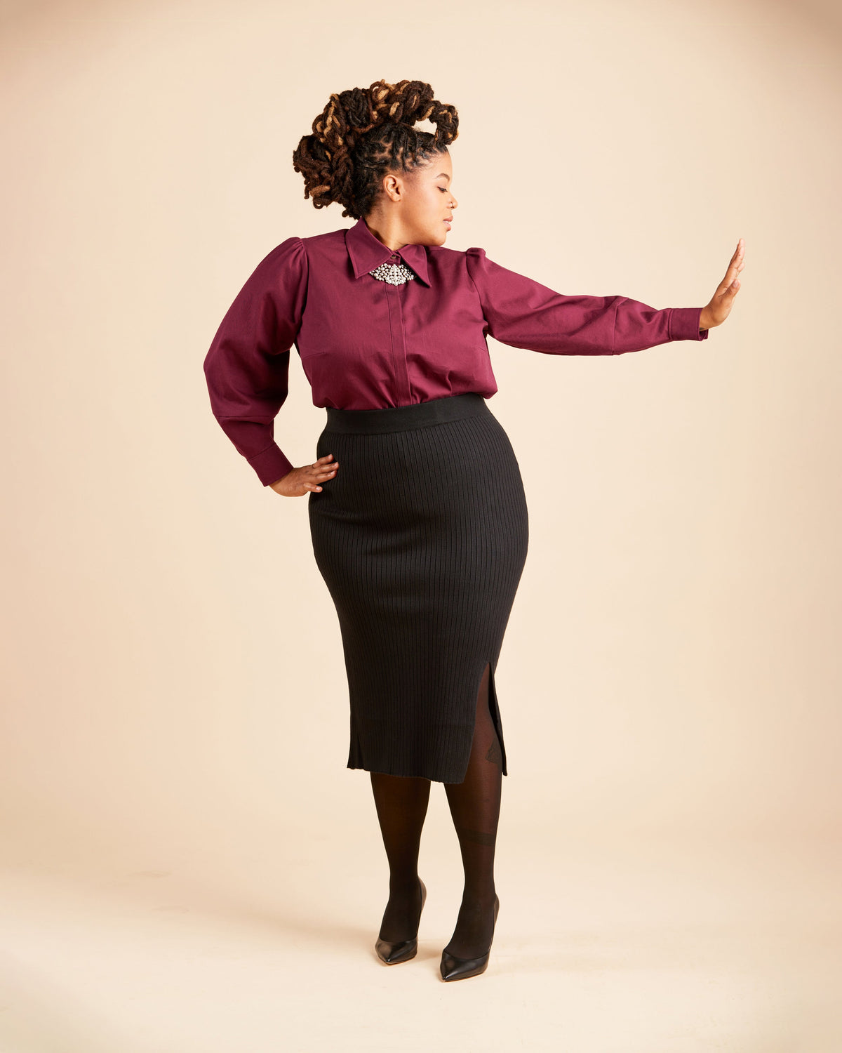 Cashmerette Vernon Shirt PDF sewing pattern, woman wearing a burgundy blouse and black skirt, burgundy side view