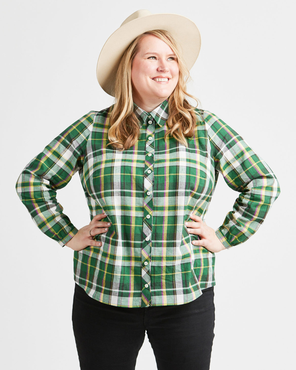 Cashmerette Vernon Shirt PDF sewing pattern, woman wearing a green plaid shirt and a beige hat