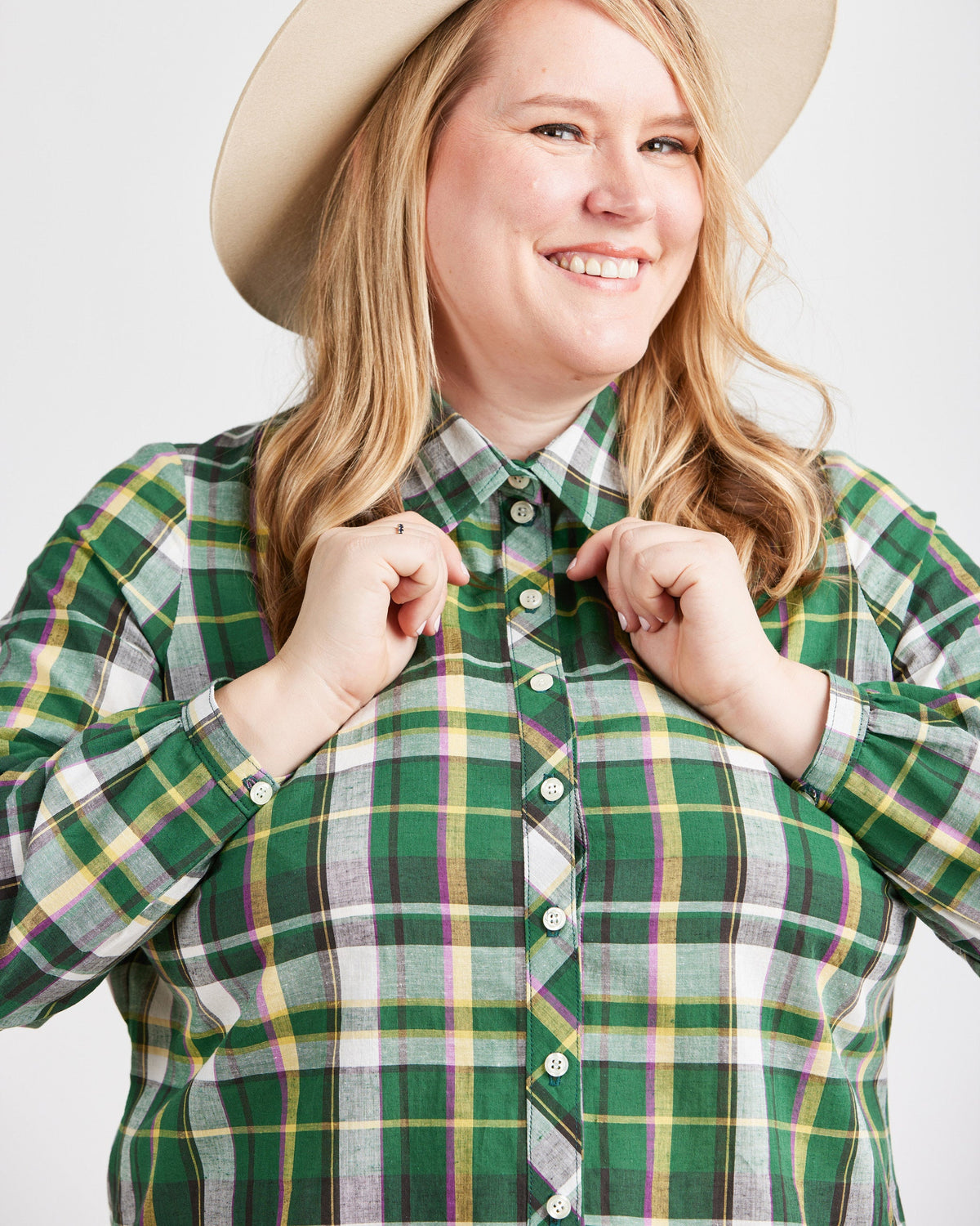 Cashmerette Vernon Shirt PDF sewing pattern, person wearing a green plaid shirt with a beige hat