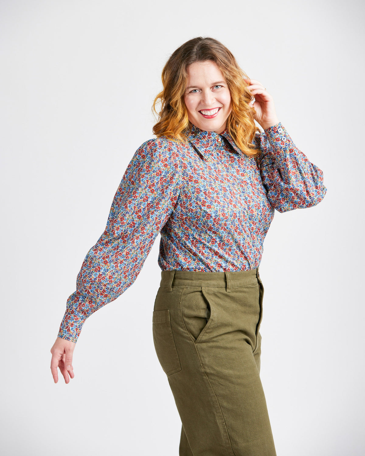 Cashmerette Vernon Shirt PDF sewing pattern, woman wearing a patterned blouse and green pants
